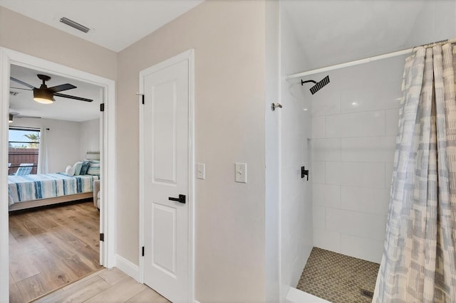 2301 Cass St, Sarasota, FL 34231 - full bathroom featuring ceiling fan, ensuite bath, wood finished floors, visible vents, and tiled shower