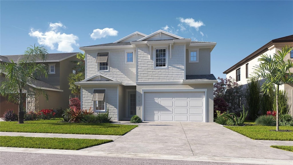 view of front of house featuring a garage, concrete driveway, and a front lawn