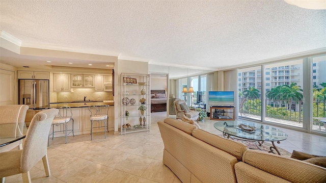 1212 Benjamin Franklin Dr Unit 503, Sarasota, FL 34236 - living area featuring plenty of natural light, ornamental molding, a textured ceiling, and expansive windows