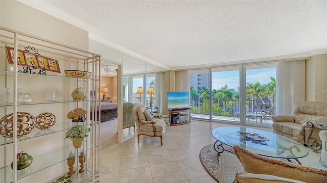1212 Benjamin Franklin Dr Unit 503, Sarasota, FL 34236 - tiled living room featuring a textured ceiling, floor to ceiling windows, and ornamental molding