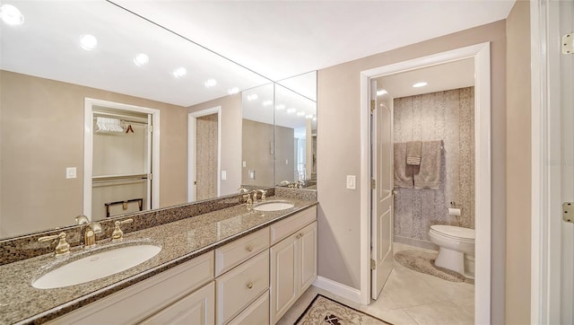 1212 Benjamin Franklin Dr Unit 503, Sarasota, FL 34236 - bathroom featuring a sink, tile patterned floors, baseboards, and toilet