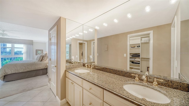 1212 Benjamin Franklin Dr Unit 503, Sarasota, FL 34236 - ensuite bathroom featuring connected bathroom, double vanity, tile patterned floors, and a sink