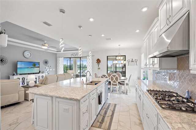 10819 Wicker Park Pl, Palmetto, FL 34221 - kitchen featuring decorative backsplash, marble finish floor, under cabinet range hood, a sink, and stainless steel appliances