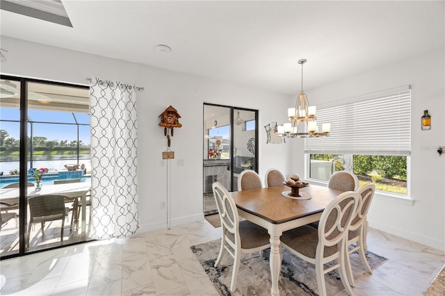 10819 Wicker Park Pl, Palmetto, FL 34221 - dining space with baseboards, a water view, marble finish floor, and a notable chandelier