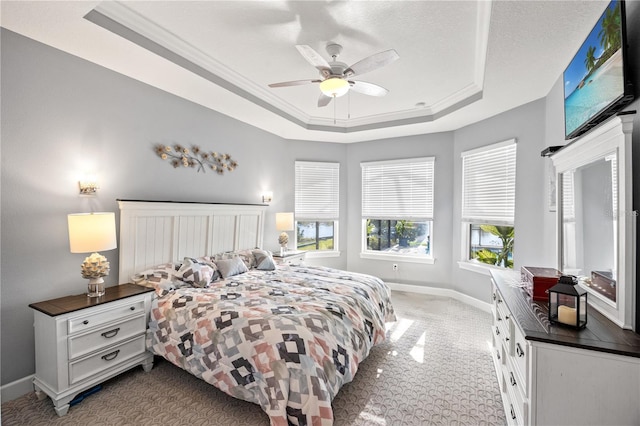 10819 Wicker Park Pl, Palmetto, FL 34221 - carpeted bedroom featuring baseboards, a ceiling fan, crown molding, and a tray ceiling