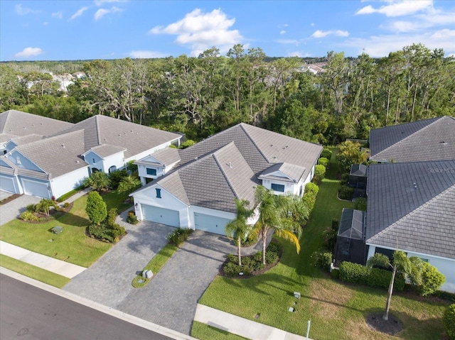 birds eye view of property featuring a view of trees