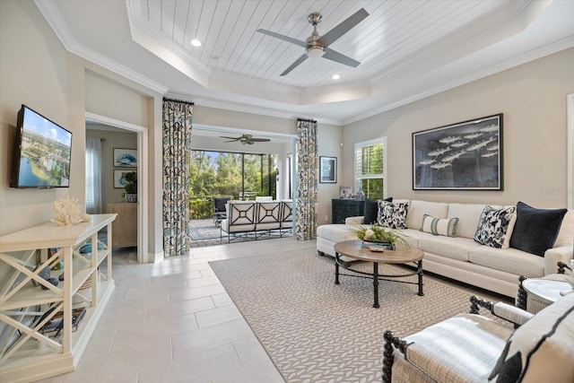 living room with a ceiling fan, recessed lighting, ornamental molding, and a raised ceiling