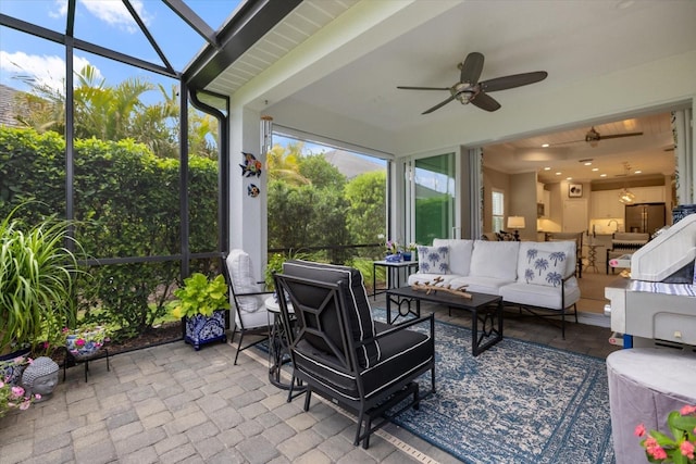 sunroom featuring a ceiling fan and an outdoor hangout area