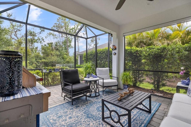 sunroom featuring a ceiling fan and an outdoor hangout area
