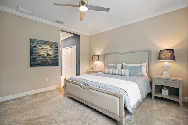 carpeted bedroom with baseboards, visible vents, ornamental molding, and a closet