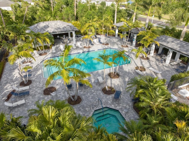 pool with a gazebo, a patio area, and fence