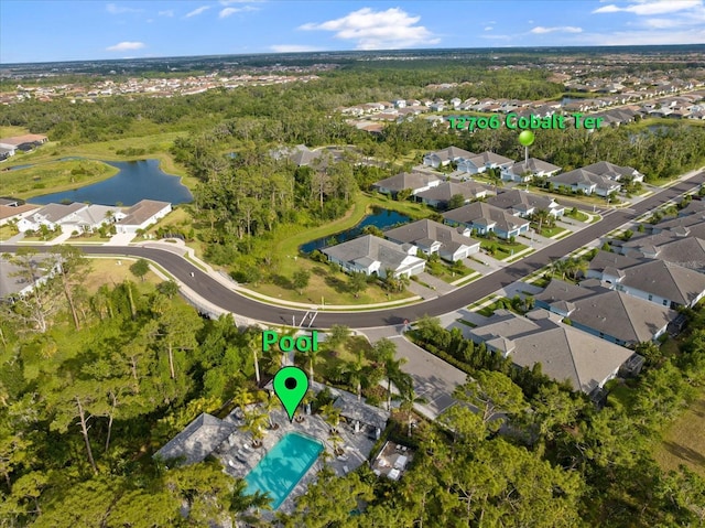 birds eye view of property with a water view and a residential view