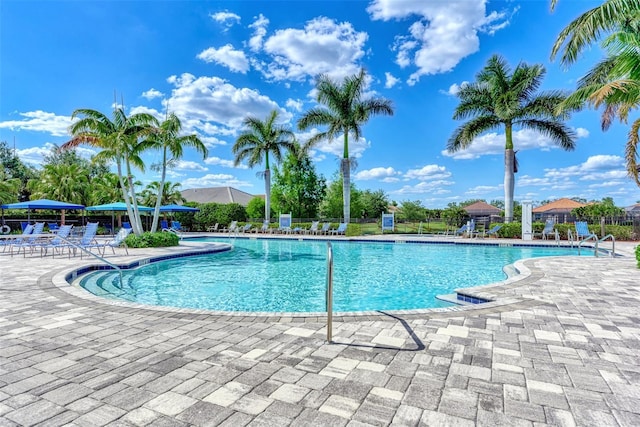 pool with fence and a patio area