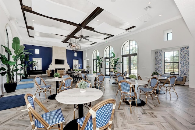 dining room featuring ceiling fan, visible vents, crown molding, baseboards, and coffered ceiling