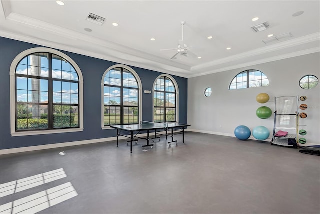 game room with visible vents, a ceiling fan, a raised ceiling, and baseboards