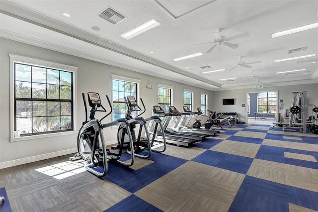 gym with baseboards, visible vents, ceiling fan, and carpet