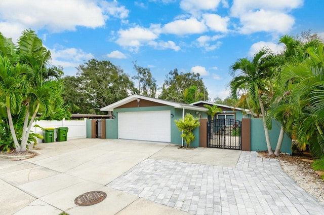 exterior space featuring fence, driveway, and a gate
