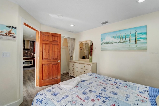 bedroom featuring recessed lighting, wood finished floors, and visible vents