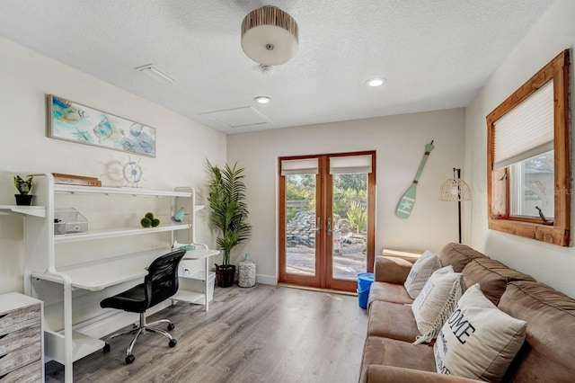 office with a textured ceiling, french doors, attic access, recessed lighting, and wood finished floors
