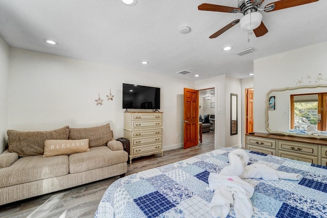 bedroom with visible vents, recessed lighting, and wood finished floors