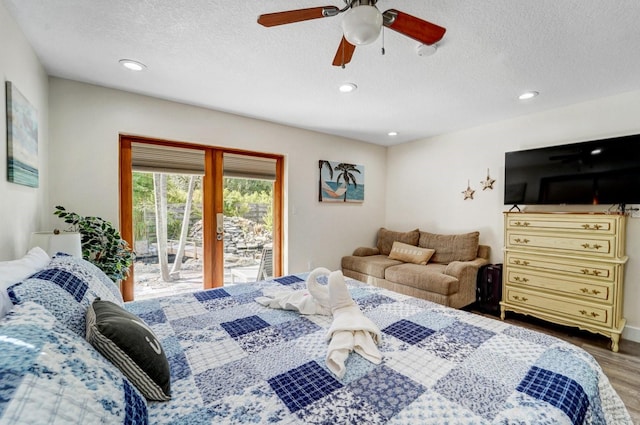bedroom with access to outside, a textured ceiling, recessed lighting, and wood finished floors