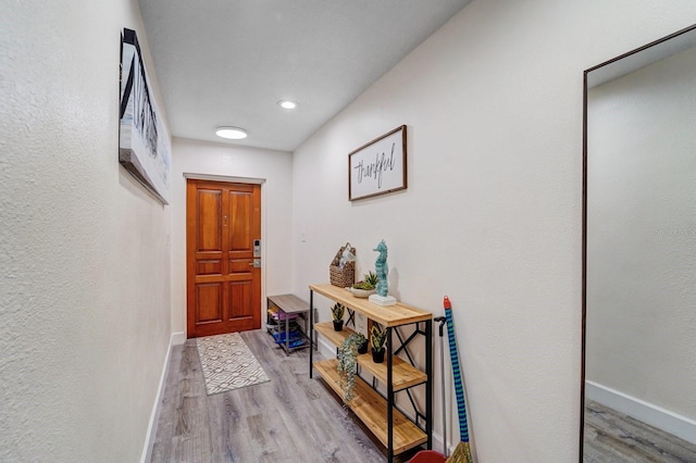 entryway with baseboards, recessed lighting, and wood finished floors