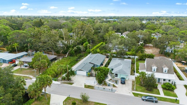 drone / aerial view featuring a view of trees and a residential view