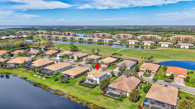 bird's eye view with a residential view, a water view, and golf course view
