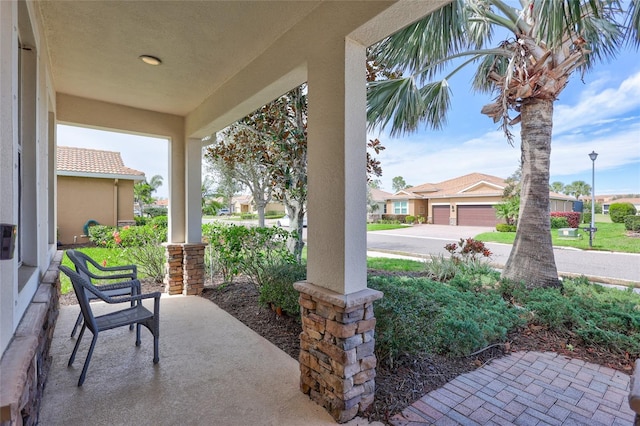 view of patio featuring covered porch and a residential view