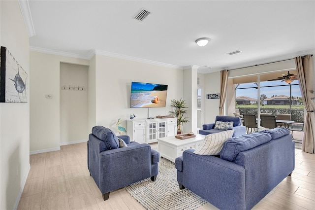 living area featuring crown molding, baseboards, and visible vents