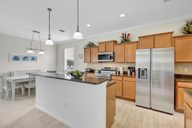 kitchen with a center island, decorative backsplash, dark stone counters, and appliances with stainless steel finishes