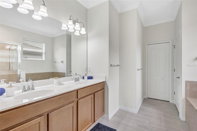 full bath featuring a garden tub, a sink, and ornamental molding