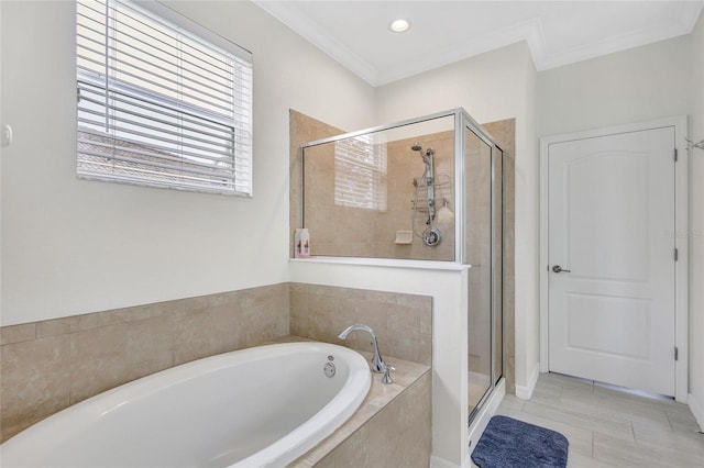 full bath featuring a garden tub, crown molding, and a shower stall