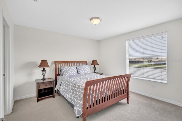 bedroom featuring baseboards and carpet