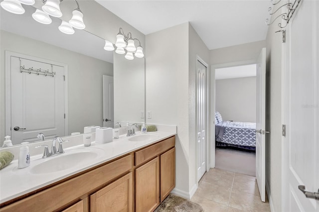 ensuite bathroom with double vanity, a sink, connected bathroom, and tile patterned floors