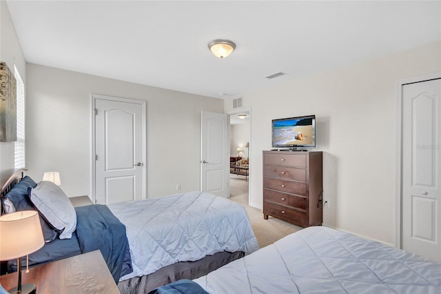 bedroom featuring visible vents and light carpet