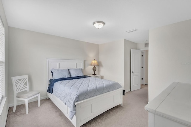 bedroom featuring baseboards, light carpet, and visible vents