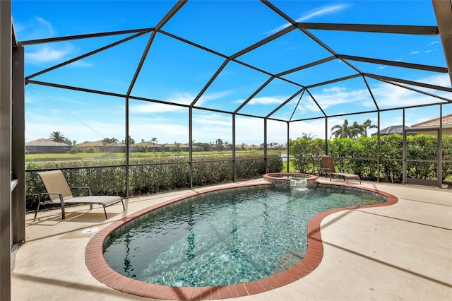 view of swimming pool with glass enclosure, a patio area, and a pool with connected hot tub