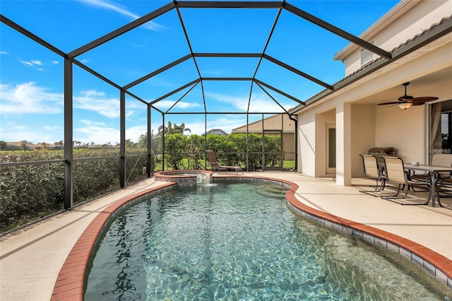 view of pool featuring a ceiling fan, a lanai, a pool with connected hot tub, and a patio area