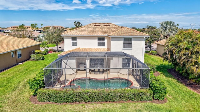 back of property featuring stucco siding, an outdoor pool, a patio area, a lawn, and glass enclosure