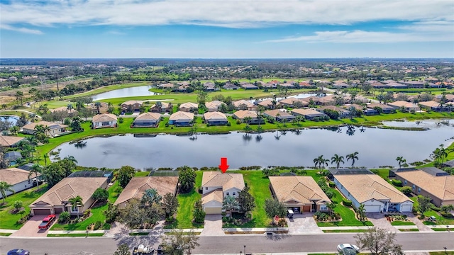 drone / aerial view featuring a water view and a residential view