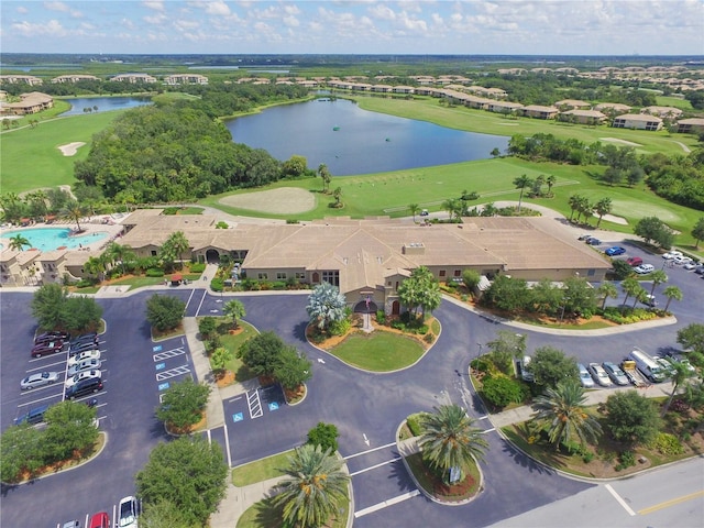 drone / aerial view featuring view of golf course and a water view