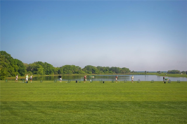 view of community with a lawn and a water view