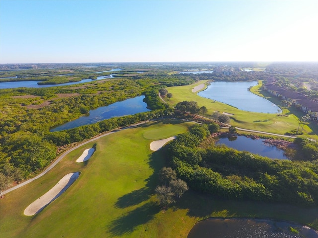 drone / aerial view with a water view and view of golf course