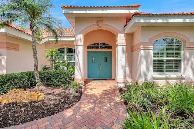 4730 Old Farm Rd, Sarasota, FL 34233 - view of exterior entry featuring stucco siding and a tiled roof
