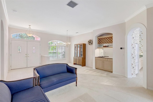 4730 Old Farm Rd, Sarasota, FL 34233 - living area featuring visible vents, light colored carpet, arched walkways, a notable chandelier, and ornamental molding