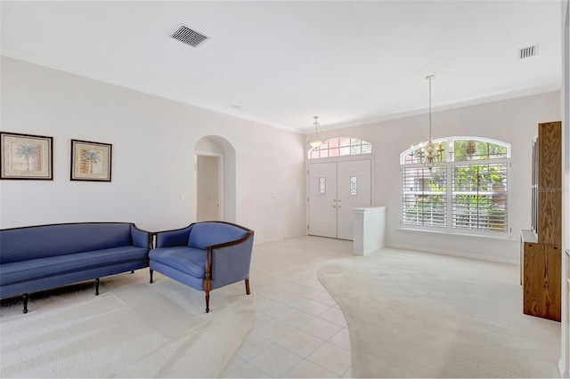 4730 Old Farm Rd, Sarasota, FL 34233 - living room featuring visible vents, arched walkways, an inviting chandelier, and light colored carpet
