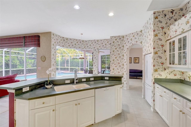 4730 Old Farm Rd, Sarasota, FL 34233 - kitchen featuring dark countertops, wallpapered walls, and a sink