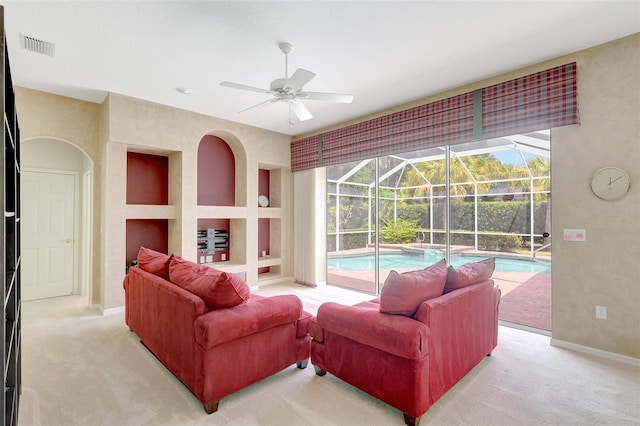 4730 Old Farm Rd, Sarasota, FL 34233 - living room with visible vents, baseboards, ceiling fan, a sunroom, and light colored carpet