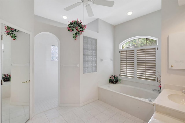 4730 Old Farm Rd, Sarasota, FL 34233 - bathroom featuring a ceiling fan, a bath, a walk in shower, baseboards, and tile patterned floors